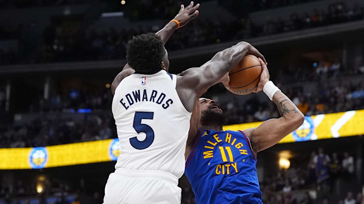 Mar 1, 2026; Denver, Colorado, USA; Minnesota Timberwolves guard Anthony Edwards (5) blocks the shot by Denver Nuggets guard Bruce Brown (11) in the second half at Ball Arena.