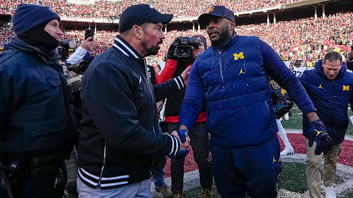 Ohio State Buckeyes head coach Ryan Day shakes hands with Michigan Wolverines head coach Sherrone Moore following Michigan's 13-10 victory.