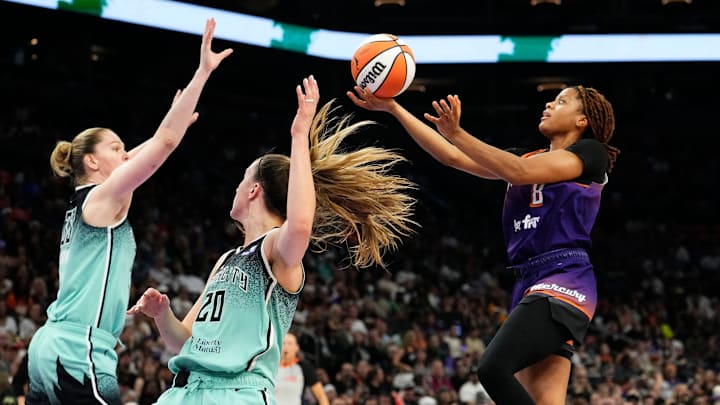 Phoenix Mercury guard Monique Akoa Makani (8) takes a shot over New York Liberty guard Sabrina Ionescu (20) in the first half during Game Three of the 2025 WNBA Playoffs first round at PHX Arena on Sept. 19, 2025, in Phoenix.
