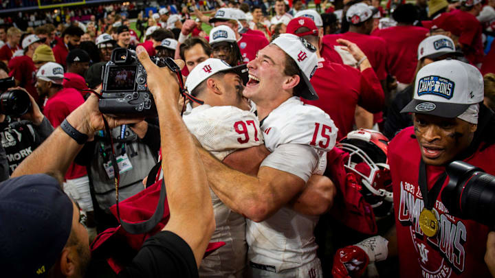 Indiana quarterback Fernando Mendoza embraces defensive lineman Mario Landino after winning the Big Ten championship game. Indiana quarterback Fernando Mendoza embraces defensive lineman Mario Landino after winning the Big Ten championship game.