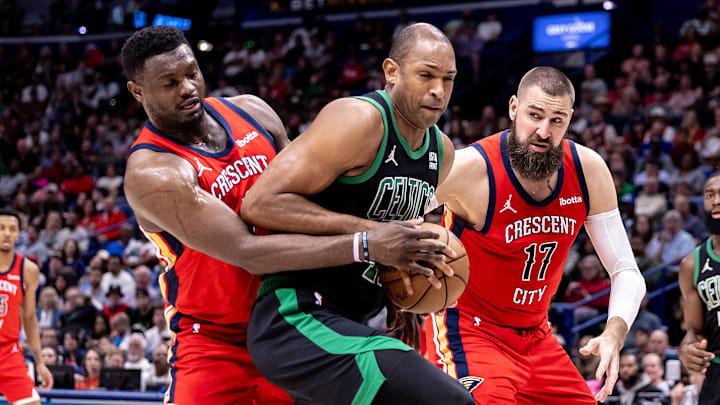 Mar 30, 2024; New Orleans, Louisiana, USA; Boston Celtics center Al Horford (42) is defended by New Orleans Pelicans forward Zion Williamson (1) and center Jonas Valanciunas (17) during the second half at Smoothie King Center. Mandatory Credit: Stephen Lew-Imagn Images Mar 30, 2024; New Orleans, Louisiana, USA; Boston Celtics center Al Horford (42) is defended by New Orleans Pelicans forward Zion Williamson (1) and center Jonas Valanciunas (17) during the second half at Smoothie King Center. Mandatory Credit: Stephen Lew-Imagn Images