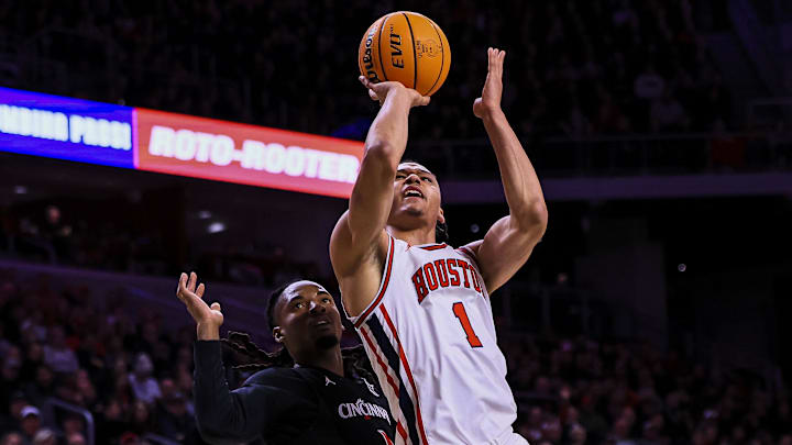 Jan 3, 2026; Cincinnati, Ohio, USA; Houston Cougars guard Isiah Harwell (1) shoots against Cincinnati Bearcats guard Day Day Thomas (1) in the first half at Fifth Third Arena. 