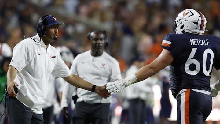 Virginia Cavaliers head coach Tony Elliott and Virginia Cavaliers offensive lineman Drake Metcalf 
