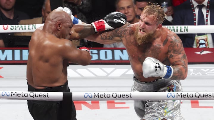Mike Tyson (black gloves) fights Jake Paul (silver gloves) at AT&T Stadium. 