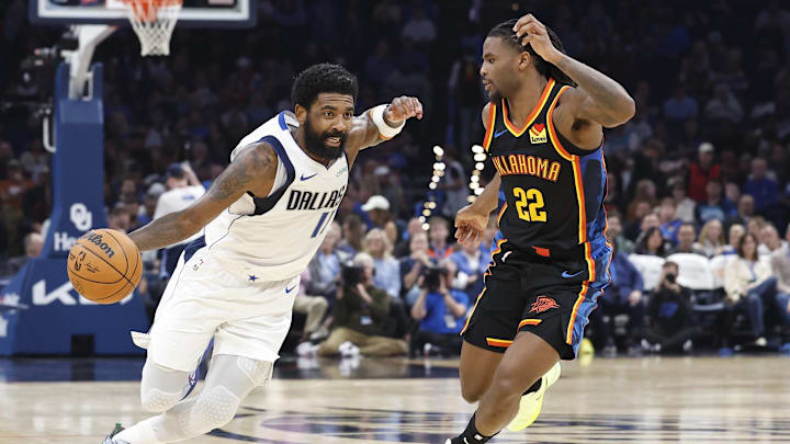 Nov 17, 2024; Oklahoma City, Oklahoma, USA; Dallas Mavericks guard Kyrie Irving (11) drives around Oklahoma City Thunder guard Cason Wallace (22) during the second quarter at Paycom Center. Mandatory Credit: Alonzo Adams-Imagn Images
