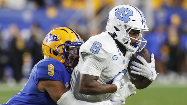 Sep 23, 2023; Pittsburgh, Pennsylvania, USA; North Carolina Tar Heels wide receiver Nate McCollum (6) secures a catch against Pittsburgh Panthers defensive back A.J. Woods (9) during the third quarter at Acrisure Stadium. The Tar Heels won 41-24. Mandatory Credit: Charles LeClaire-USA TODAY Sports