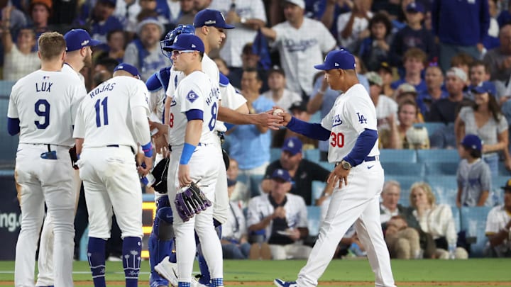 Oct 6, 2024; Los Angeles, California, USA; Los Angeles Dodgers manager Dave Roberts (30) relieves pitcher Jack Flaherty (0) in the sixth inning against the San Diego Padres during game two of the NLDS for the 2024 MLB Playoffs at Dodger Stadium. Mandatory Credit: Kiyoshi Mio-Imagn Images