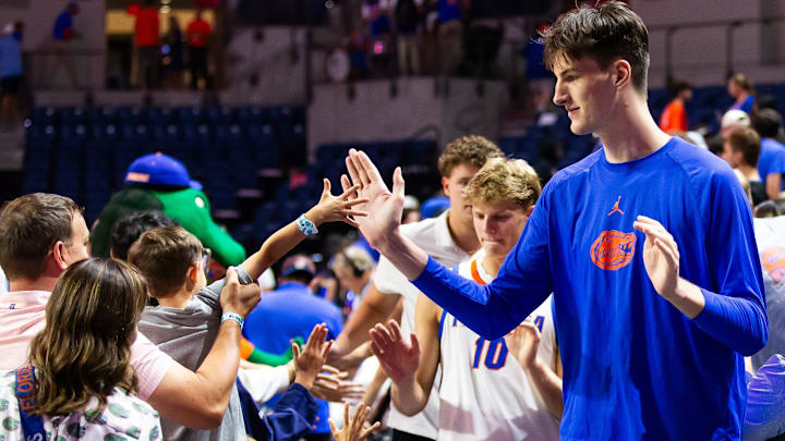 Florida Gators center Olivier Rioux (32) gives a fan a high-five after the game. The Florida Gators hosted the Grambling Tigers at Exactech Area at the Stephen C. O'Connell Center in Gainesville, FL on Monday, November 11, 2024. Gators defeated the Tigers 86-62. [Doug Engle/Gainesville Sun]