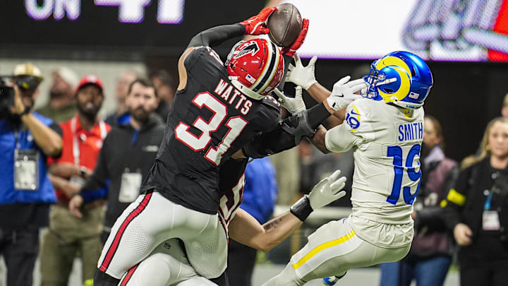 Atlanta Falcons safety Xavier Watts (31) intercepts a pass over Los Angeles Rams wide receiver Xavier Smith (19) during the first half.