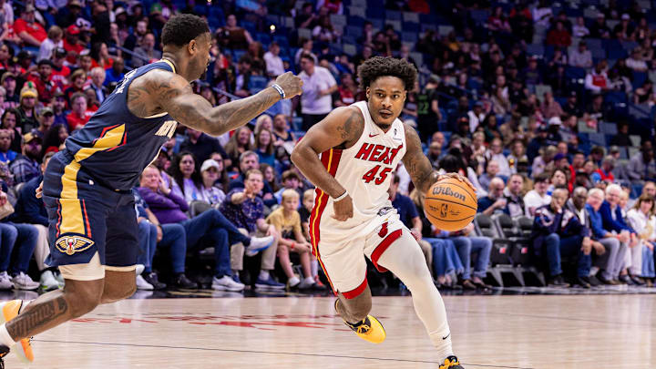 Feb 11, 2026; New Orleans, Louisiana, USA; Miami Heat guard Davion Mitchell (45) dribbles against New Orleans Pelicans forward Zion Williamson (1) during the first half at Smoothie King Center. Mandatory Credit: Stephen Lew-Imagn Images