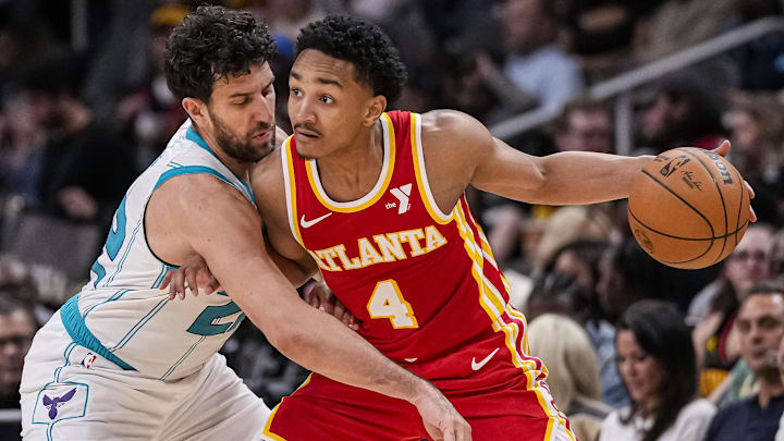 Apr 10, 2024; Atlanta, Georgia, USA; Atlanta Hawks guard Kobe Bufkin (4) is defended by Charlotte Hornets guard Vasilije Micic (22) during the second half at State Farm Arena. Mandatory Credit: Dale Zanine-Imagn Images