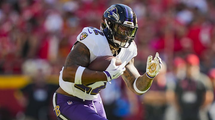 Sep 28, 2025; Kansas City, Missouri, USA; Baltimore Ravens running back Derrick Henry (22) runs the ball during the first half against the Kansas City Chiefs at GEHA Field at Arrowhead Stadium. 