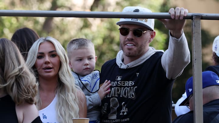 Los Angeles Dodgers first base Freddie Freeman (right) celebrates with his wife Chelsea Freeman during the 2024 World Series Championship parade in downtown Los Angeles on November 1, 2024. 