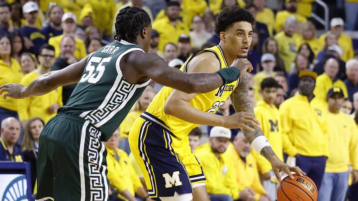 Mar 8, 2026; Ann Arbor, Michigan, USA; Michigan Wolverines forward Yaxel Lendeborg (23) dribbles defended by Michigan State Spartans forward Coen Carr (55) in the first half at Crisler Center. Mandatory Credit: Rick Osentoski-Imagn Images Mar 8, 2026; Ann Arbor, Michigan, USA; Michigan Wolverines forward Yaxel Lendeborg (23) dribbles defended by Michigan State Spartans forward Coen Carr (55) in the first half at Crisler Center. Mandatory Credit: Rick Osentoski-Imagn Images