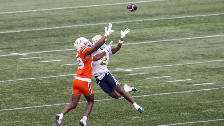 Nov 9, 2024; Atlanta, Georgia, USA; Miami Hurricanes defensive back OJ Frederique Jr. (29) breaks up a pass intended for Georgia Tech Yellow Jackets wide receiver Eric Singleton Jr. (2) in the second quarter at Bobby Dodd Stadium at Hyundai Field. Mandatory Credit: Brett Davis-Imagn Images