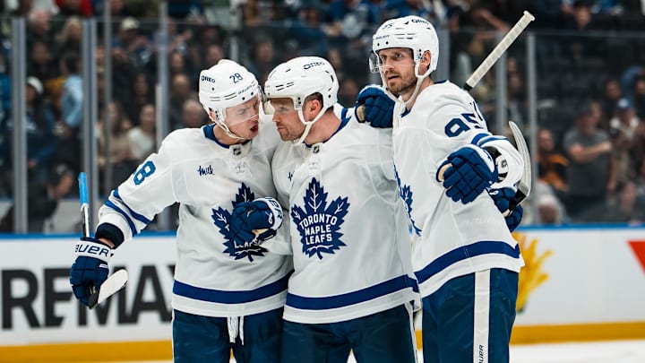 Jan 31, 2026; Vancouver, British Columbia, CAN; Toronto Maple Leafs defenseman Troy Stecher (28) and forward Max Domi (11) and defenseman Oliver Ekman-Larsson (95) celebrate Domi’s goal against the Vancouver Canucks in the third period at Rogers Arena. Mandatory Credit: Bob Frid-Imagn Images