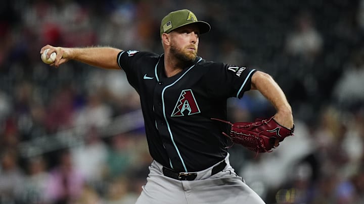 May 15, 2026; Denver, Colorado, USA; Arizona Diamondbacks starting pitcher Merrill Kelly (29) delivers a pitch in the ninth inning against the Colorado Rockies at Coors Field. Mandatory Credit: Ron Chenoy-Imagn Images