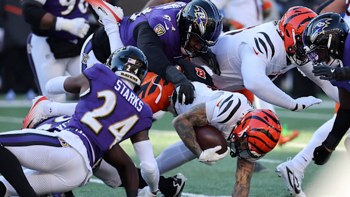 Dec 14, 2025; Cincinnati, Ohio, USA; Cincinnati Bengals running back Chase Brown (30) runs the ball as Baltimore Ravens safety Malaki Starks (24) and defensive tackle John Jenkins (94) make the tackle during the second quarter at Paycor Stadium. Mandatory Credit: Joseph Maiorana-Imagn Images Dec 14, 2025; Cincinnati, Ohio, USA; Cincinnati Bengals running back Chase Brown (30) runs the ball as Baltimore Ravens safety Malaki Starks (24) and defensive tackle John Jenkins (94) make the tackle during the second quarter at Paycor Stadium. Mandatory Credit: Joseph Maiorana-Imagn Images
