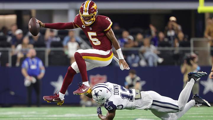 Sep 20, 2026; Arlington, Texas, USA; Washington Commanders quarterback Jayden Daniels (5) leaps to avoid a tackle by Dallas Cowboys safety Caleb Downs (13) while running with the ball during the second half at AT&T Stadium. Mandatory Credit: Kevin Jairaj-Imagn Images Sep 20, 2026; Arlington, Texas, USA; Washington Commanders quarterback Jayden Daniels (5) leaps to avoid a tackle by Dallas Cowboys safety Caleb Downs (13) while running with the ball during the second half at AT&T Stadium. Mandatory Credit: Kevin Jairaj-Imagn Images