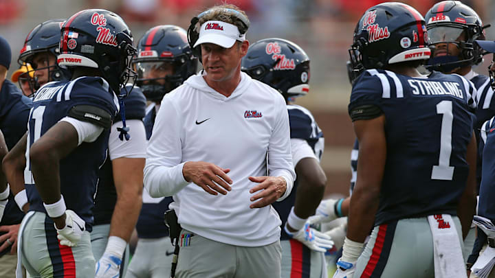 Sep 20, 2025; Oxford, Mississippi, USA; Mississippi Rebels head coach Lane Kiffin (middle) talks with wide receivers Deuce Alexander (11) and De'Zhaun Stribling (1) during a time out during the second quarter against the Tulane Green Wave at Vaught-Hemingway Stadium. Mandatory Credit: Petre Thomas-Imagn Images