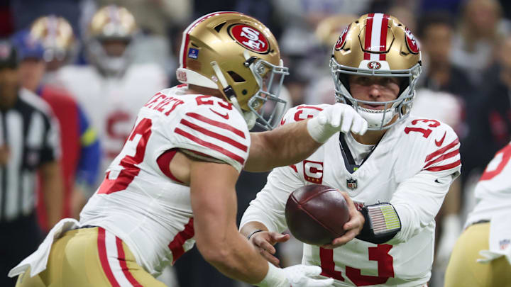 Dec 22, 2025; Indianapolis, Indiana, USA; San Francisco 49ers quarterback Brock Purdy (13) hands the ball to running back Christian McCaffrey (23) against the Indianapolis Colts in the first quarter of the game at Lucas Oil Stadium. Mandatory Credit: Trevor Ruszkowski-Imagn Images