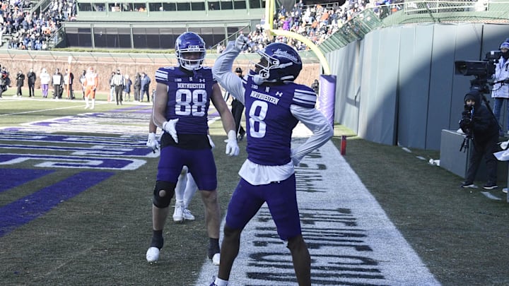 Nov 30, 2024; Chicago, Illinois, USA;  Northwestern Wildcats wide receiver A.J. Henning (8) celebrates after scoring a touchdown against the Illinois Fighting Illini during the second half at Wrigley Field. Mandatory Credit: Matt Marton-Imagn Images