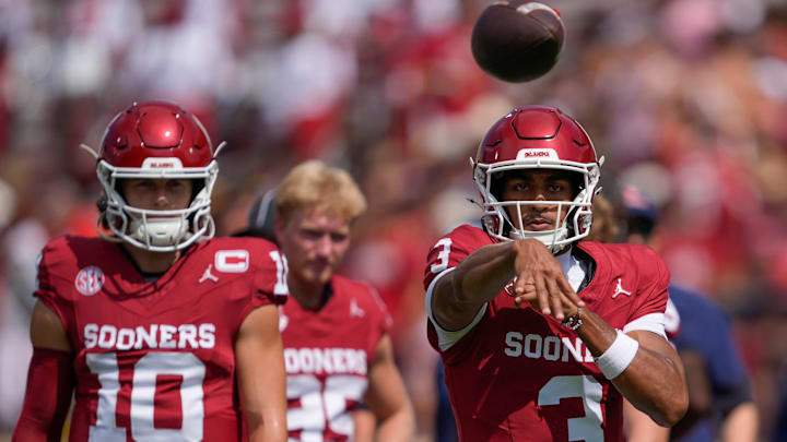 Oklahoma quarterback Michael Hawkins Jr. warms up alongside John Mateer. Oklahoma quarterback Michael Hawkins Jr. warms up alongside John Mateer.