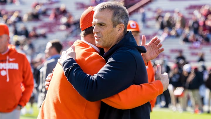 Nov 29, 2025; Columbia, South Carolina, USA; 
Clemson Tigers head coach Dabo Swinney and South Carolina Gamecocks head coach Shane Beamer hug before their game at Williams-Brice Stadium. Mandatory Credit: Jeff Blake-Imagn Images