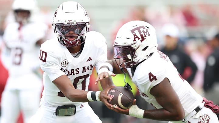 Texas A&M Aggies quarterback Marcel Reed (10) and running back Rueben Owens II (4) warm up prior to the game against the Arkansas Razorbacks at Donald W. Reynolds Razorback Stadium.