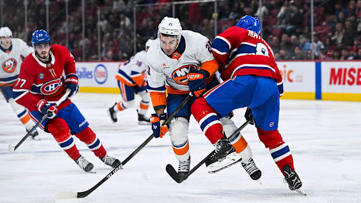 Dec 3, 2024; Montreal, Quebec, CAN; Montreal Canadiens defenseman Mike Matheson (8) defends the puck against New York Islanders center Kyle Palmieri (21) during the second period at Bell Centre. Mandatory Credit: David Kirouac-Imagn Images