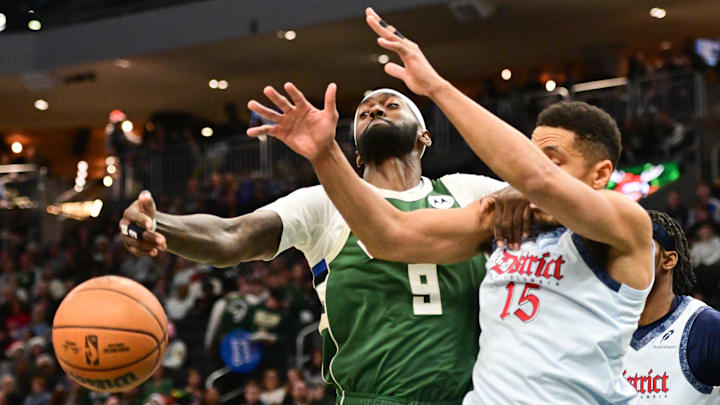 Dec 21, 2024; Milwaukee, Wisconsin, USA;  Milwaukee Bucks forward Bobby Portis (9) and Washington Wizards guard Malcolm Brogdon (15) battle for a rebound in the first quarter at Fiserv Forum. Mandatory Credit: Benny Sieu-Imagn Images