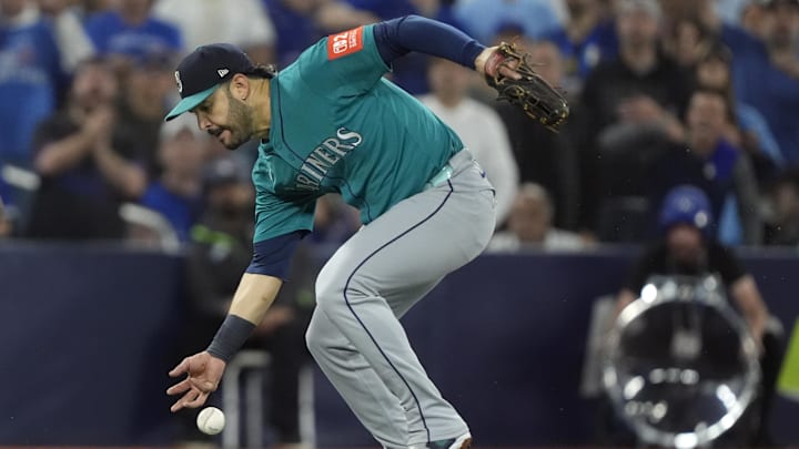 Oct 19, 2025; Toronto, Ontario, CAN; Seattle Mariners third baseman Eugenio Suarez (28) attempts to field the ball against the Toronto Blue Jays in the second inning during game six of the ALCS round for the 2025 MLB playoffs at Rogers Centre. Mandatory Credit: John E. Sokolowski-Imagn Images