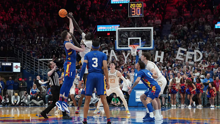 Feb 11, 2025; Lawrence, Kansas, USA; Kansas Jayhawks center Hunter Dickinson (1) and Colorado Buffaloes forward Bangot Dak (8) fight for the opening jump ball during the first half at Allen Fieldhouse. Mandatory Credit: Denny Medley-Imagn Images