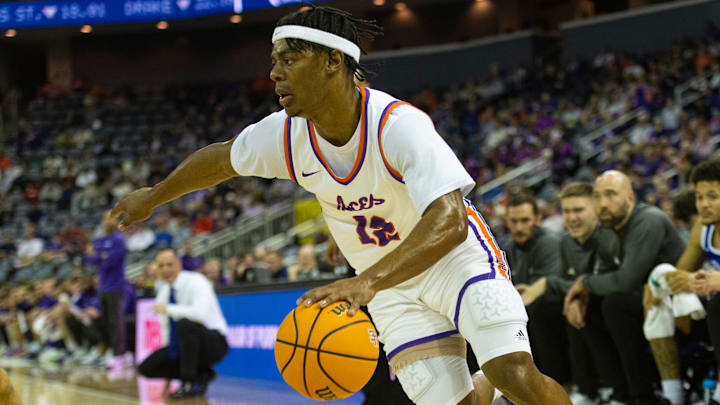 Evansville's Tayshawn Comer (12) drives as the Evansville Purple Aces play the Drake Bulldogs at Ford Center in Evansville, Ind., Wednesday, Feb. 26, 2025.