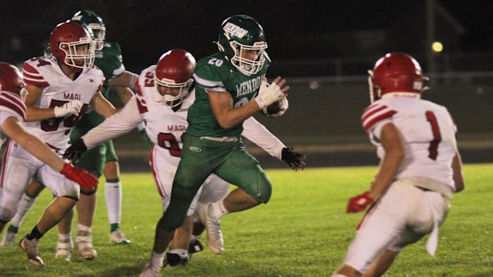 Senior tailback Owen Gorham (20) runs the ball for the Mendon varsity football team in Michigan. The Hornets won their playoff opener after Grand Rapids Sacred Heart forfeited due to a scheduling conflict.