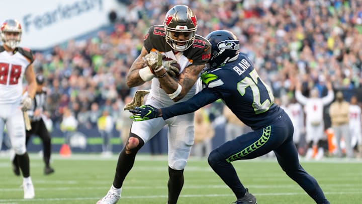 Nov 3, 2019; Seattle, WA, USA; Tampa Bay Buccaneers wide receiver Mike Evans (13) fights for yards while being tackled by Seattle Seahawks defensive back Marquise Blair (27) during the second half at CenturyLink Field. Seattle defeated Tampa Bay 40-34. Mandatory Credit: Steven Bisig-Imagn Images