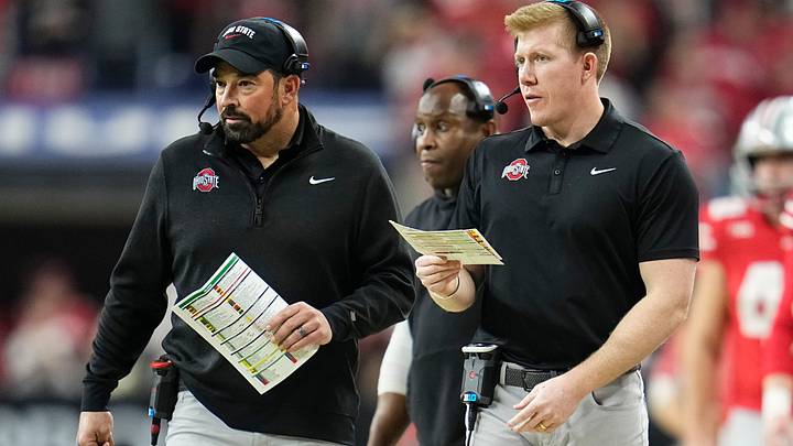 Ohio State Buckeyes tight ends coach Keenan Bailey, right, and head coach Ryan Day walk along the sideline during the Big Ten Conference championship game at Lucas Oil Stadium in Indianapolis on Dec. 6, 2025. Ohio State lost 13-10.