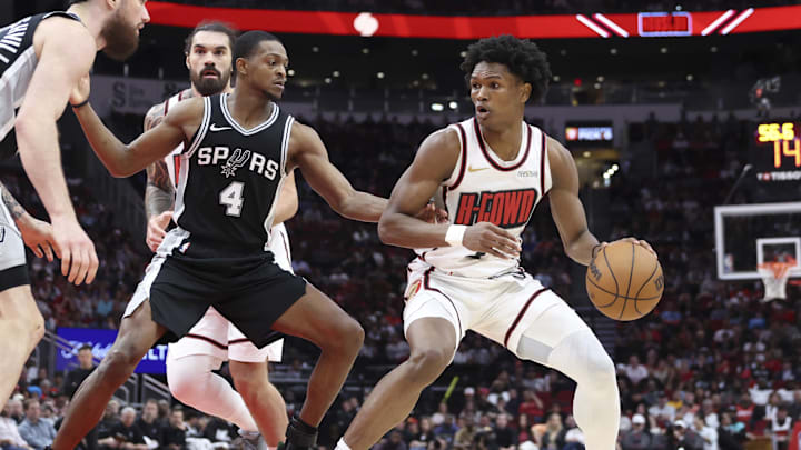 Feb 26, 2025; Houston, Texas, USA; Houston Rockets forward Amen Thompson (1) controls the ball as San Antonio Spurs guard De'Aaron Fox (4) defends during the third quarter at Toyota Center. Mandatory Credit: Troy Taormina-Imagn Images