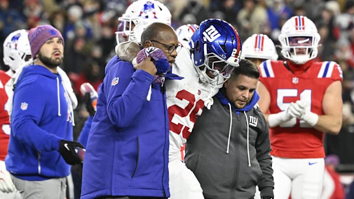 Dec 1, 2025; Foxborough, Massachusetts, USA; New York Giants running back Tyrone Tracy Jr. (29) is helped off the field during the fourth quarter against the New England Patriots at Gillette Stadium. Dec 1, 2025; Foxborough, Massachusetts, USA; New York Giants running back Tyrone Tracy Jr. (29) is helped off the field during the fourth quarter against the New England Patriots at Gillette Stadium.