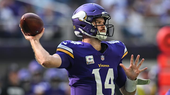 Oct 20, 2024; Minneapolis, Minnesota, USA; Minnesota Vikings quarterback Sam Darnold (14) throws a pass against the Detroit Lions during the first quarter at U.S. Bank Stadium.