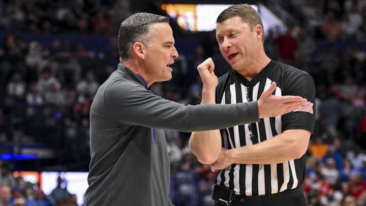 Mar 12, 2025; Nashville, TN, USA; LSU Tigers head coach Matt McMahon talks with the referee against the Mississippi State Bulldogs during the first half at Bridgestone Arena. Mandatory Credit: Steve Roberts-Imagn Images