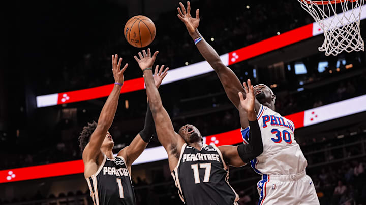 Mar 7, 2026; Atlanta, Georgia, USA; Atlanta Hawks forward Jalen Johnson (1) and forward/center Onyeka Okongwu (17) and Philadelphia 76ers forward Adem Bona (30) reach for a rebound during the first half at State Farm Arena. Mandatory Credit: Dale Zanine-Imagn Images