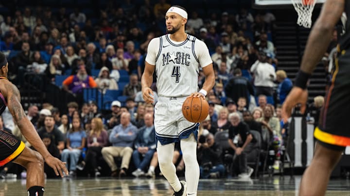 Orlando Magic guard Jalen Suggs (4) dribbles the ball against the Phoenix Suns in the first quarter at Kia Center.