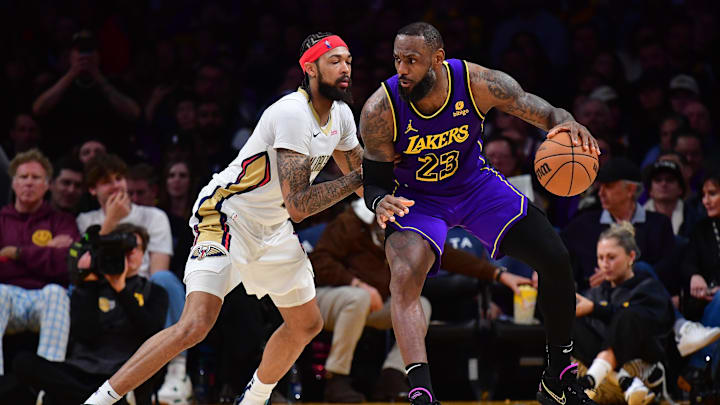 Feb 9, 2024; Los Angeles, California, USA; Los Angeles Lakers forward LeBron James (23) moves the ball against New Orleans Pelicans forward Brandon Ingram (14) during the second half at Crypto.com Arena. Mandatory Credit: Gary A. Vasquez-Imagn Images