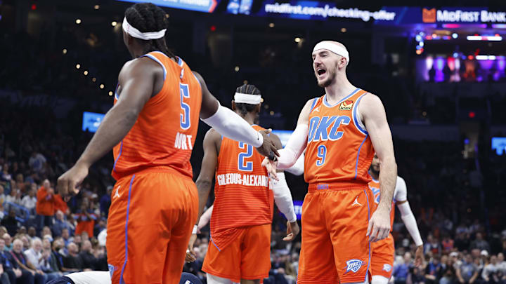 Dec 10, 2024; Oklahoma City, Oklahoma, USA; Oklahoma City Thunder guard Alex Caruso (9) celebrates with Oklahoma City Thunder guard Luguentz Dort (5) after scoring against the Dallas Mavericks during the second quarter at Paycom Center. Mandatory Credit: Alonzo Adams-Imagn Images