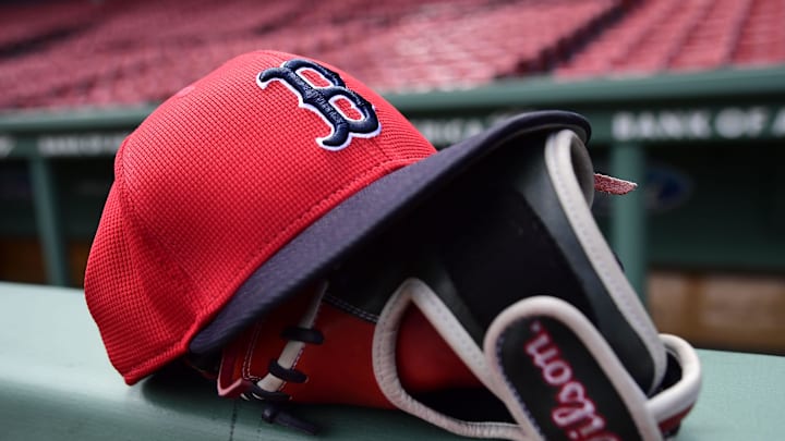 Boston, Massachusetts, USA; A Boston Red Sox hat and glove rest on the railing by the dugout prior to a game against the Atlanta Braves at Fenway Park. Boston, Massachusetts, USA; A Boston Red Sox hat and glove rest on the railing by the dugout prior to a game against the Atlanta Braves at Fenway Park.