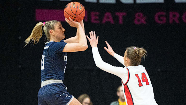 Cedar Rapids Xavier's Libby Fandel attempts a shot against North Polk's Campbell Schulz during the 4A IGHSAU state basketball championship at Wells Fargo Arena on Saturday, March 8, 2025, in Des Moines.