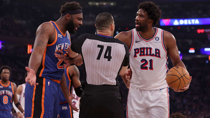 Apr 30, 2024; New York, New York, USA; New York Knicks center Mitchell Robinson (23) has words with Philadelphia 76ers center Joel Embiid (21) and guard Kelly Oubre Jr. (9) after fouling Oubre during the first quarter of game 5 of the first round of the 2024 NBA playoffs at Madison Square Garden. Mandatory Credit: Brad Penner-Imagn Images