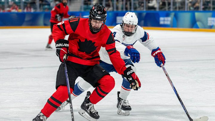 Jan 30, 2024; Gangwon-do, KOR; Tynan Lawrence (CAN) skates with the puck while under pressure from AJ Francisco (USA) in the Ice Hockey Men s 6-on-6 Tournament Semifinals between Canada and (USA) at the Gangneung Hockey Centre. The Winter Youth Olympic Games, Gangwon, South Korea, Tuesday 30 January 2024. Mandatory Credit: OIS/Thomas Lovelock-Imagn Images