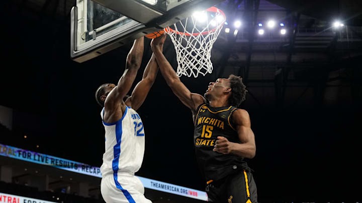 Mar 14, 2025; Fort Worth, TX, USA;  Memphis Tigers center Moussa Cisse (32) has his dunk blocked by Wichita State Shockers center Quincy Ballard (15) during the first half at Dickies Arena. Mandatory Credit: Chris Jones-Imagn Images